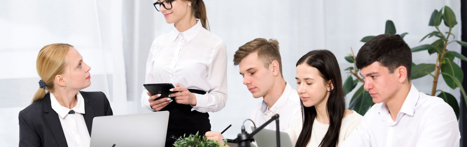 female-manager-discussing-project-with-her-colleagues-office